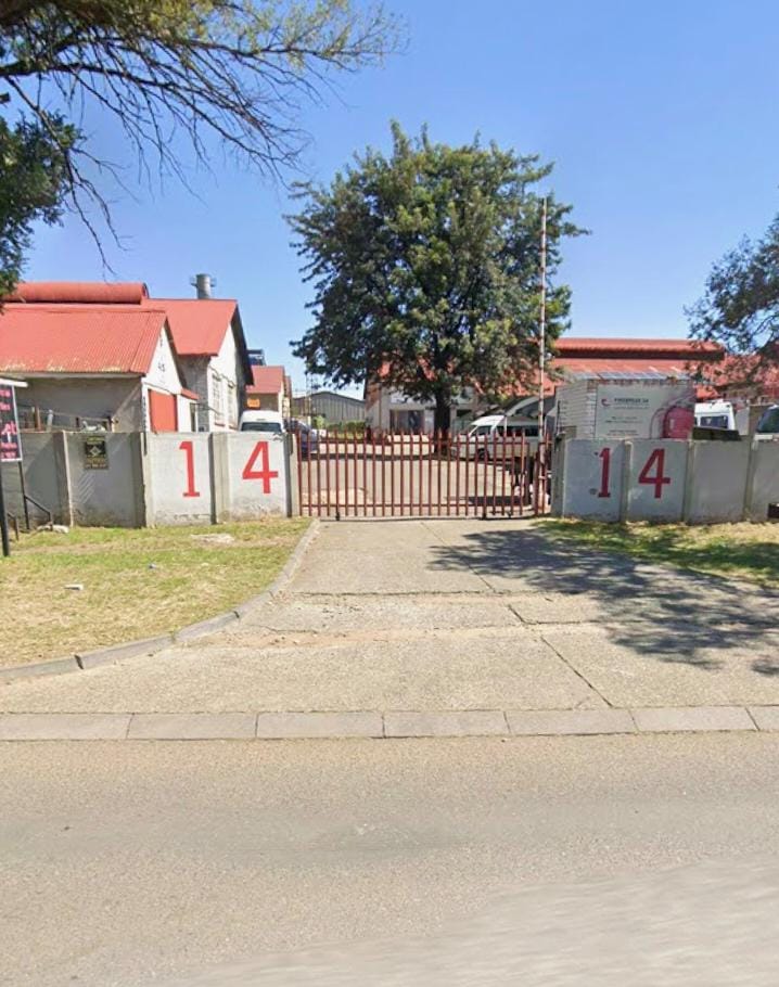 Entrance to the Get Guttered premises at number 14, with work vehicles in the yard
